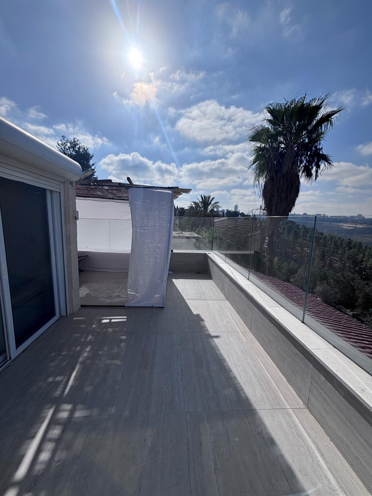 Private terrace beneath blue Jerusalem sky