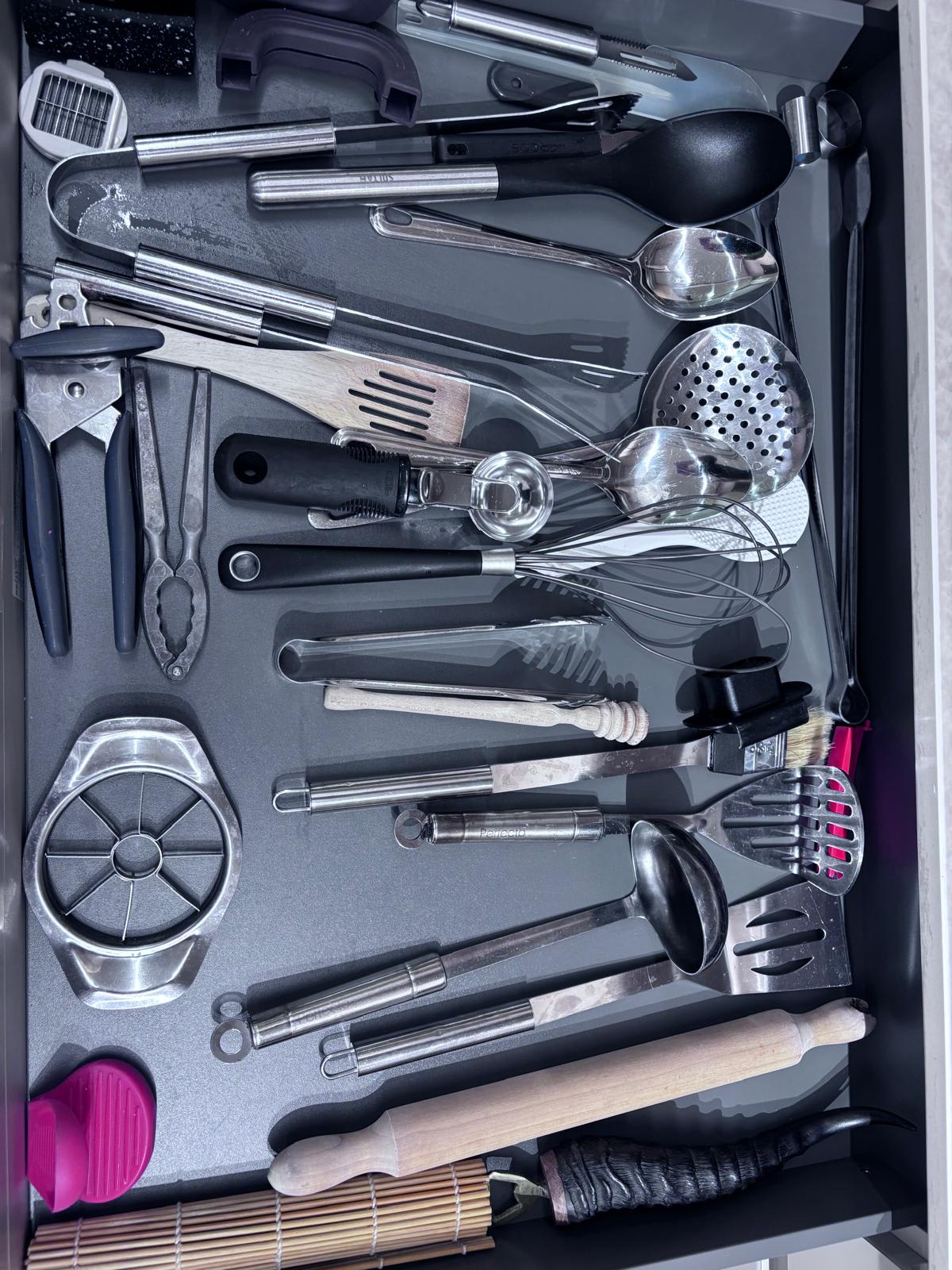 Fitted kitchen drawer holding a full set of cooking tools